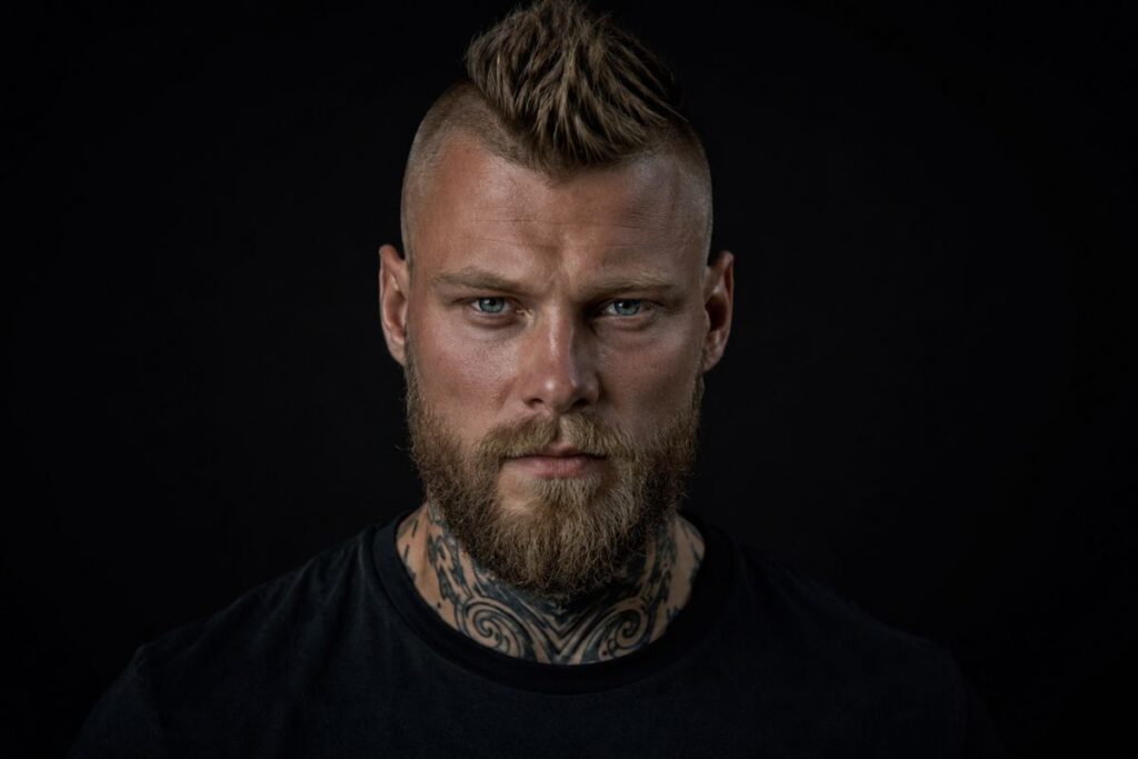 Viking mohawk fade with textured center strip and very short faded sides