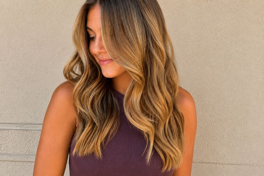 Woman with warm caramel blonde hair in sunlight