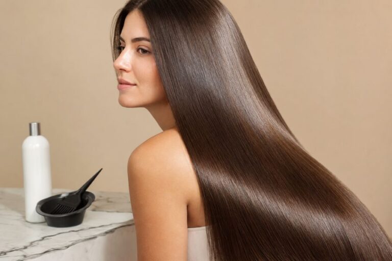 Woman with long, smooth, glossy brunette hair after a professional keratin hair treatment.