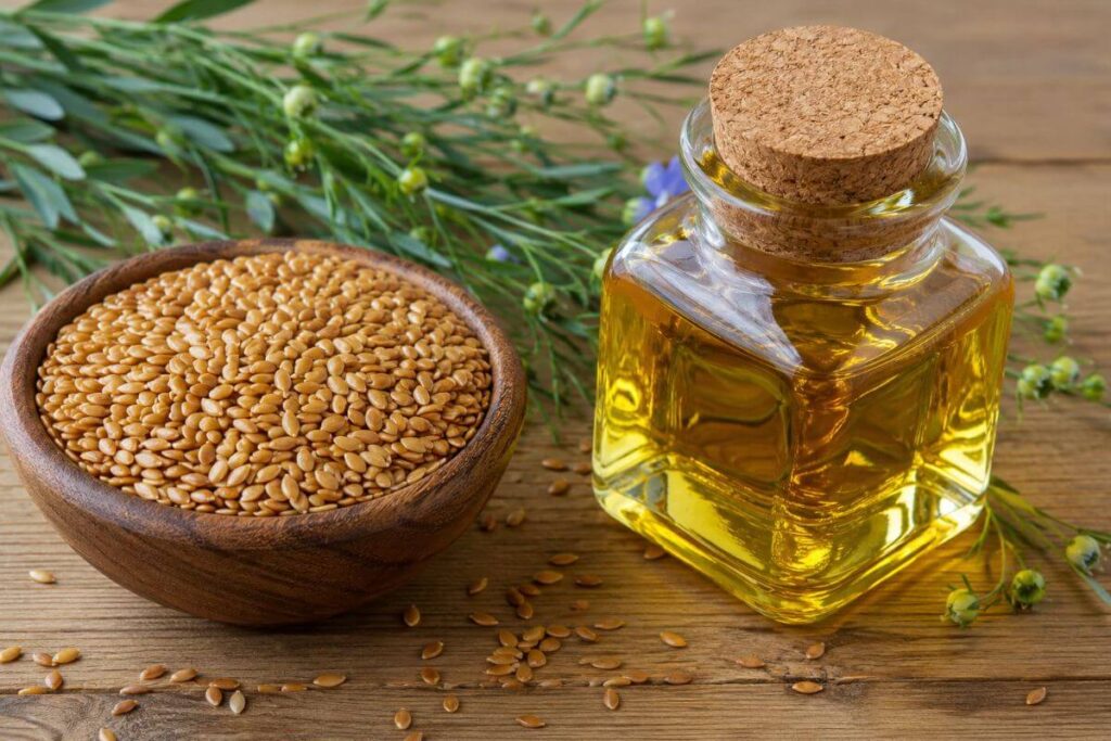 Whole flaxseeds and cold-pressed flaxseed oil used for natural hair care and scalp nourishment.