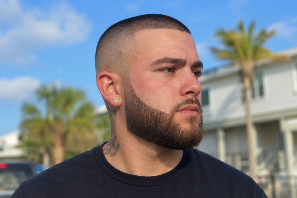 Skin buzz hairstyle paired with beard for round face shape men