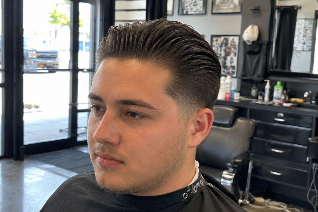Slicked back hairstyle for round face shape men